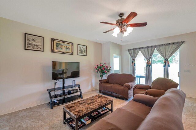 living room featuring baseboards and a ceiling fan