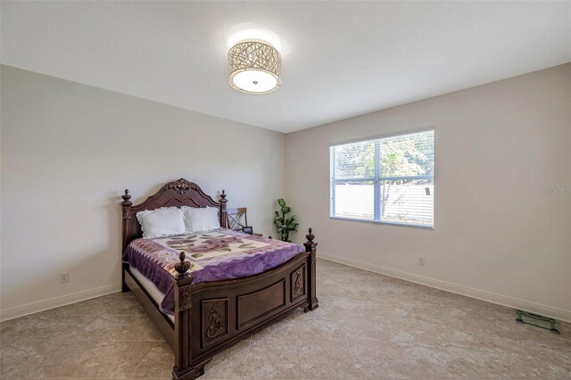 bedroom featuring baseboards and light tile patterned floors