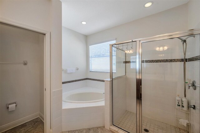 bathroom featuring recessed lighting, a stall shower, and a bath