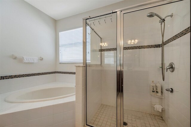 bathroom featuring a shower stall and a garden tub