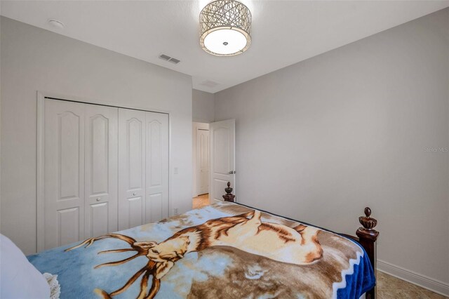 bedroom with a closet and visible vents