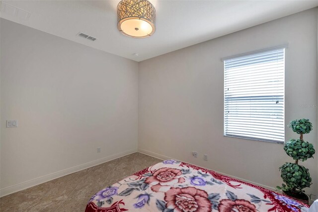 bedroom with visible vents and baseboards