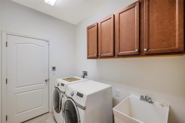 laundry room featuring a sink, cabinet space, and washing machine and clothes dryer