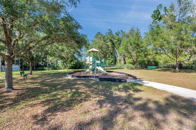 communal playground with a lawn and fence