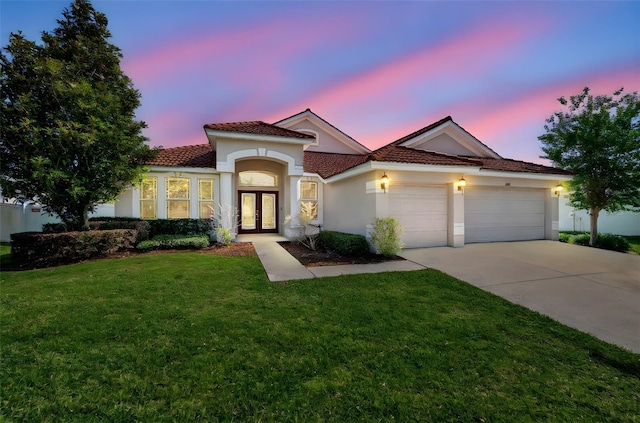 2218 Valterra Vista Way, Valrico, FL 33594 - mediterranean / spanish-style home featuring french doors, an attached garage, concrete driveway, stucco siding, and a front yard
