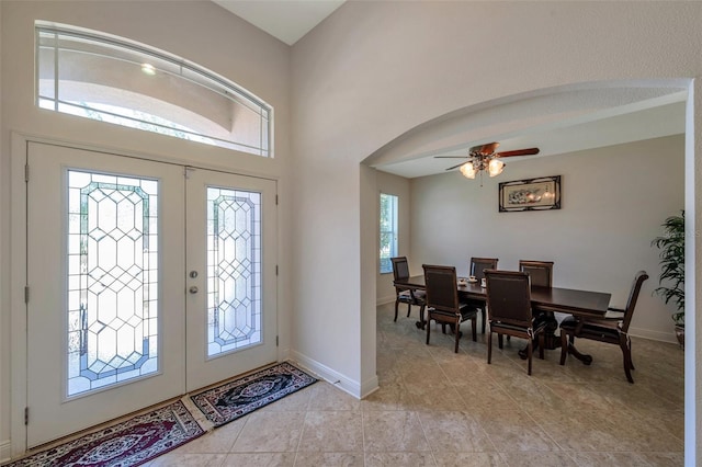 2218 Valterra Vista Way, Valrico, FL 33594 - entrance foyer with arched walkways, ceiling fan, light tile patterned floors, and baseboards