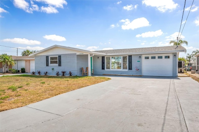 ranch-style home with a garage, a front yard, and concrete driveway