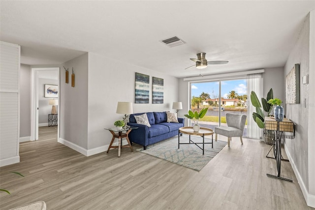 12700 5th Isle, Hudson, FL 34667 - living area featuring wood finished floors, a ceiling fan, and baseboards