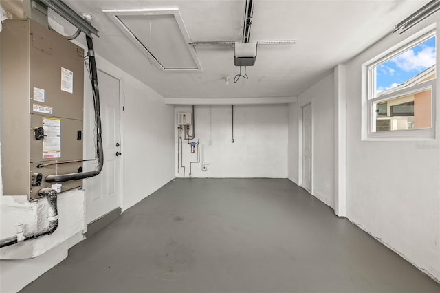 12700 5th Isle, Hudson, FL 34667 - garage featuring heating unit and a garage door opener