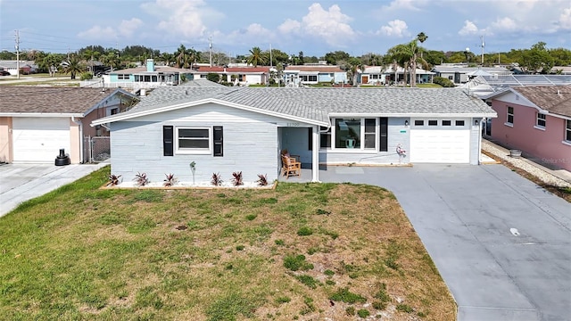 12700 5th Isle, Hudson, FL 34667 - ranch-style house featuring a residential view, concrete driveway, a front lawn, and a garage