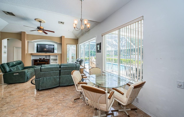 dining area featuring arched walkways, visible vents, lofted ceiling, and ceiling fan with notable chandelier