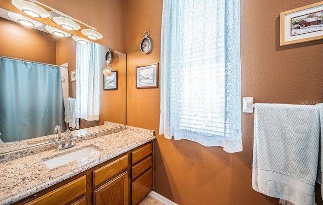 full bath with curtained shower and vanity
