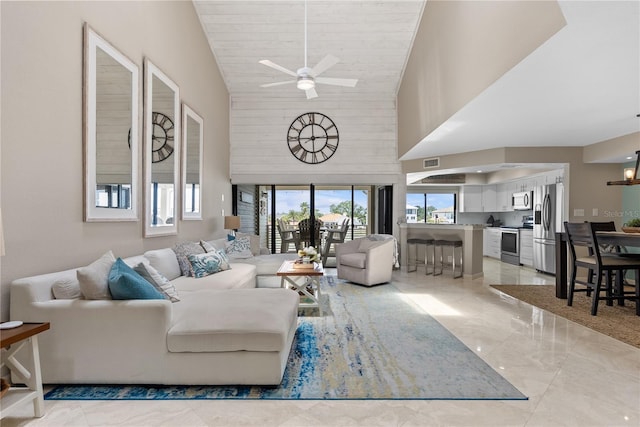 350 Pinellas Bayway S Unit 7, Tierra Verde, FL 33715 - living area with high vaulted ceiling, ceiling fan with notable chandelier, marble finish floor, and visible vents