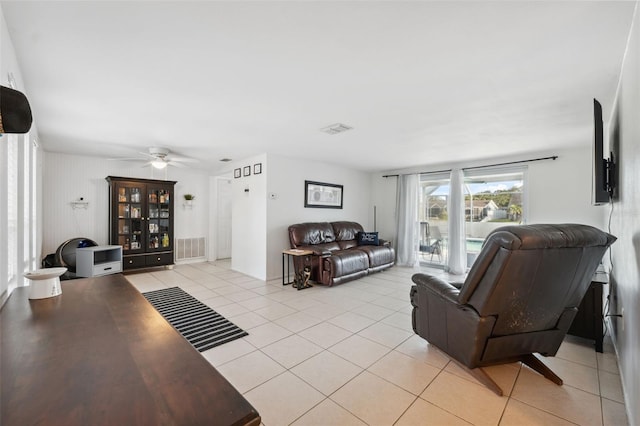living area with light tile patterned floors, ceiling fan, and visible vents