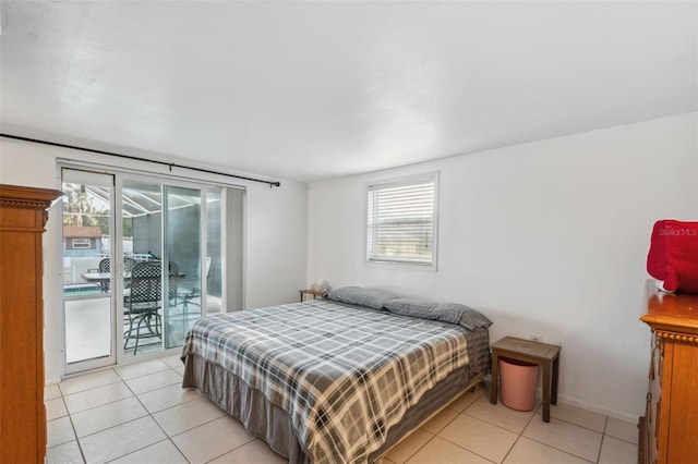 bedroom with light tile patterned floors, baseboards, and access to outside