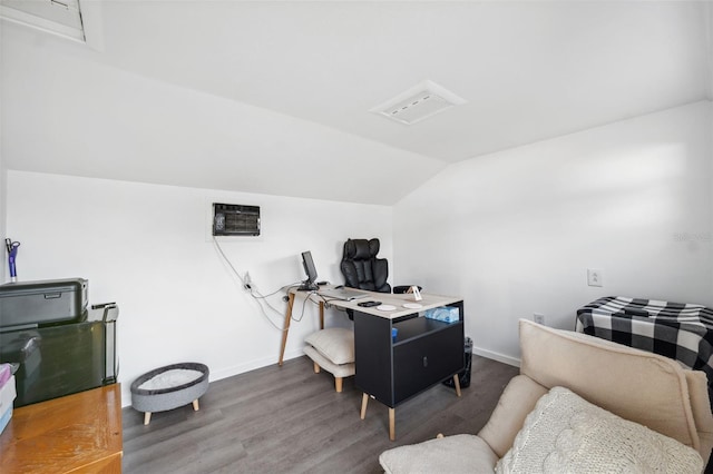 office featuring vaulted ceiling, wood finished floors, baseboards, and a wall unit AC