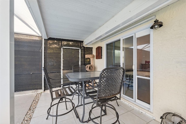 sunroom featuring outdoor dining area