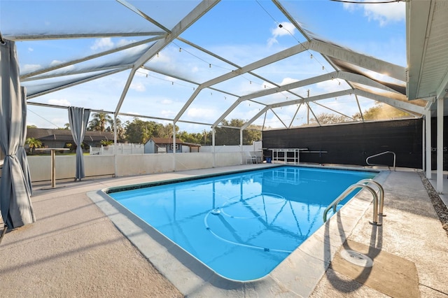 outdoor pool featuring a patio, fence, and a lanai