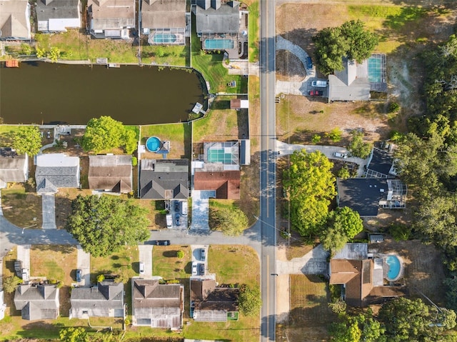 birds eye view of property featuring a water view and a residential view
