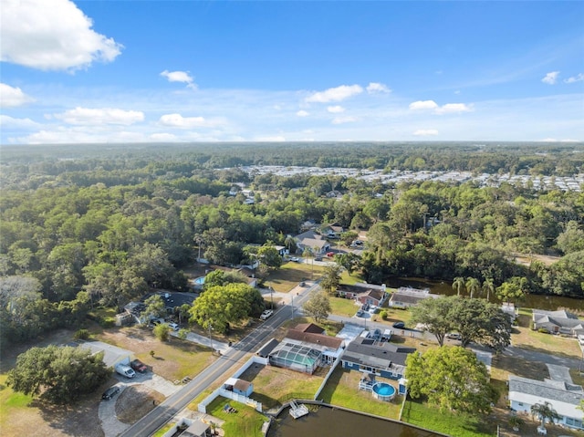 birds eye view of property with a forest view and a residential view