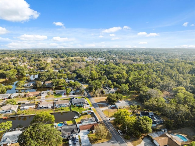 bird's eye view featuring a wooded view and a residential view