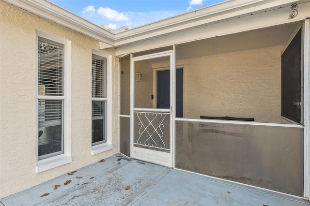 doorway to property with stucco siding