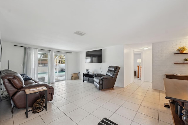 living room with light tile patterned floors and visible vents