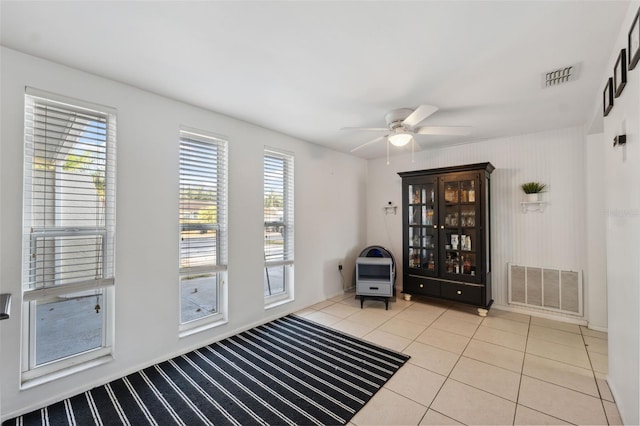 interior space featuring a ceiling fan, tile patterned floors, and visible vents