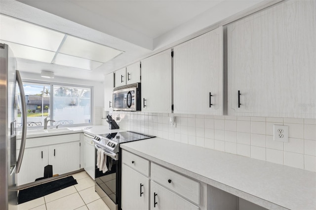 kitchen featuring light countertops, light tile patterned floors, stainless steel appliances, and backsplash