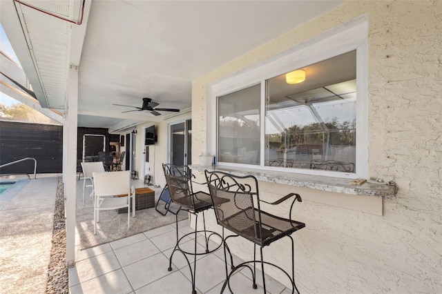 view of patio with an outdoor pool and ceiling fan