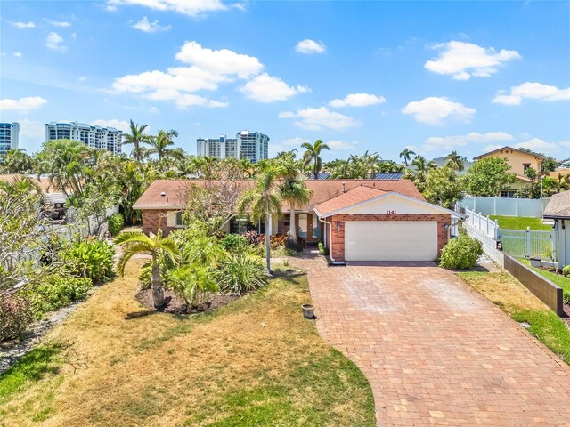 1141 80th Street Ct S, Saint Petersburg, FL 33707 - view of front of home with a garage, decorative driveway, and brick siding