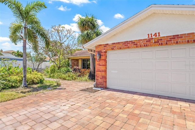1141 80th Street Ct S, Saint Petersburg, FL 33707 - view of side of property featuring brick siding and decorative driveway