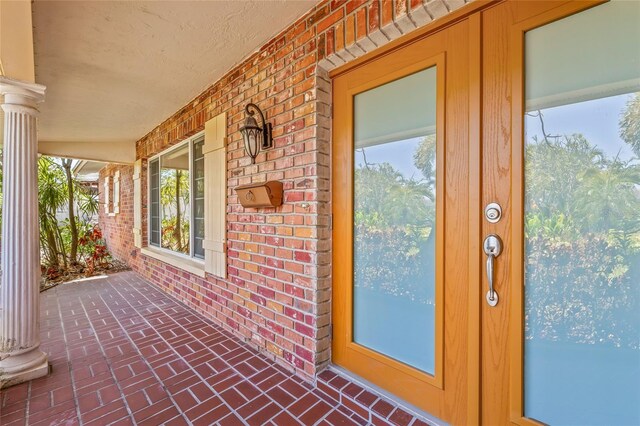 1141 80th Street Ct S, Saint Petersburg, FL 33707 - entrance to property with brick siding and a porch