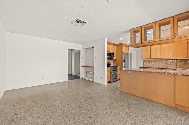1141 80th Street Ct S, Saint Petersburg, FL 33707 - kitchen featuring appliances with stainless steel finishes, light stone counters, decorative backsplash, glass insert cabinets, and a textured ceiling