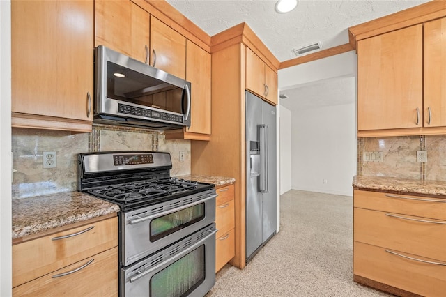 1141 80th Street Ct S, Saint Petersburg, FL 33707 - kitchen featuring stainless steel appliances, tasteful backsplash, light stone counters, and baseboards