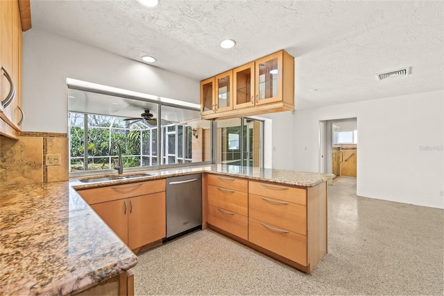 1141 80th Street Ct S, Saint Petersburg, FL 33707 - kitchen with stainless steel dishwasher, a sink, a textured ceiling, a peninsula, and ceiling fan
