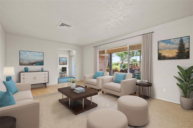 1141 80th Street Ct S, Saint Petersburg, FL 33707 - living area with speckle patterned floor and baseboards