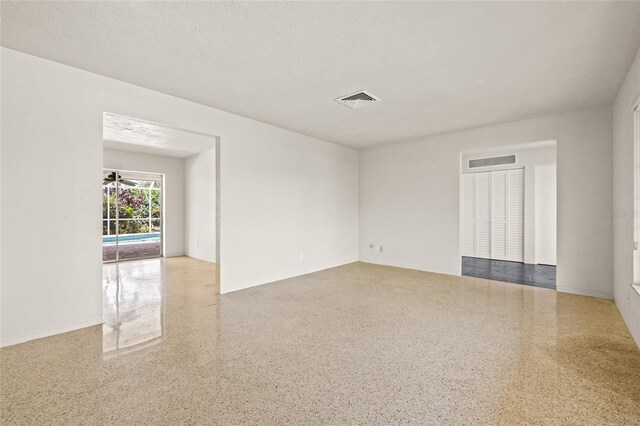 1141 80th Street Ct S, Saint Petersburg, FL 33707 - empty room with speckled floor