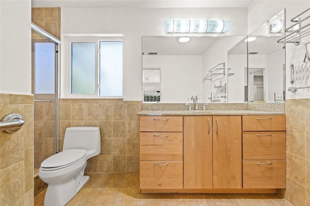 1141 80th Street Ct S, Saint Petersburg, FL 33707 - bathroom with tile walls, tiled shower, vanity, toilet, and tile patterned flooring