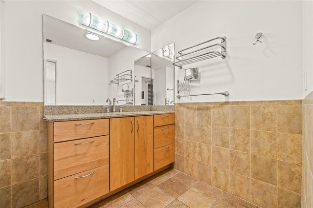 1141 80th Street Ct S, Saint Petersburg, FL 33707 - full bathroom with tile walls, vanity, and wainscoting