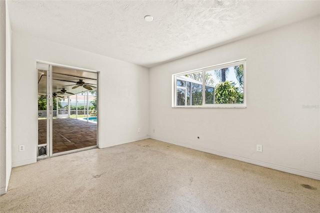 1141 80th Street Ct S, Saint Petersburg, FL 33707 - spare room featuring healthy amount of natural light, a textured ceiling, and baseboards
