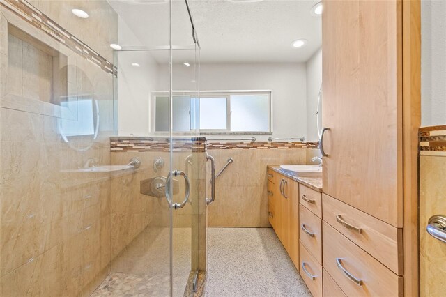 1141 80th Street Ct S, Saint Petersburg, FL 33707 - bathroom featuring vanity, a stall shower, a wainscoted wall, and recessed lighting