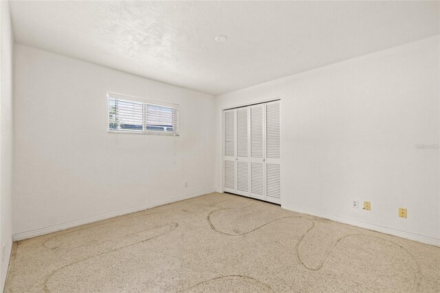 1141 80th Street Ct S, Saint Petersburg, FL 33707 - unfurnished bedroom featuring a closet and baseboards