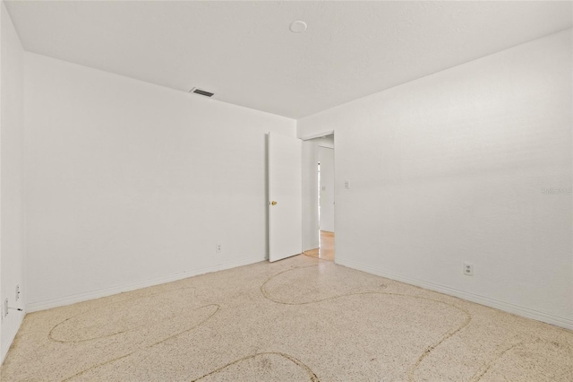 1141 80th Street Ct S, Saint Petersburg, FL 33707 - spare room featuring baseboards and dark speckled floor