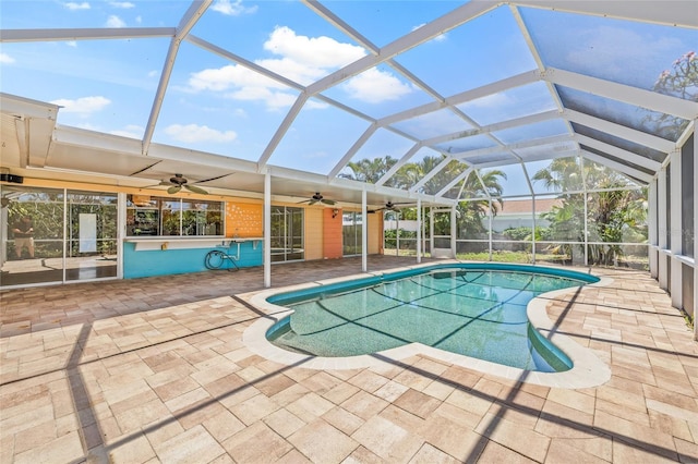 1141 80th Street Ct S, Saint Petersburg, FL 33707 - swimming pool with ceiling fan, a patio area, and glass enclosure