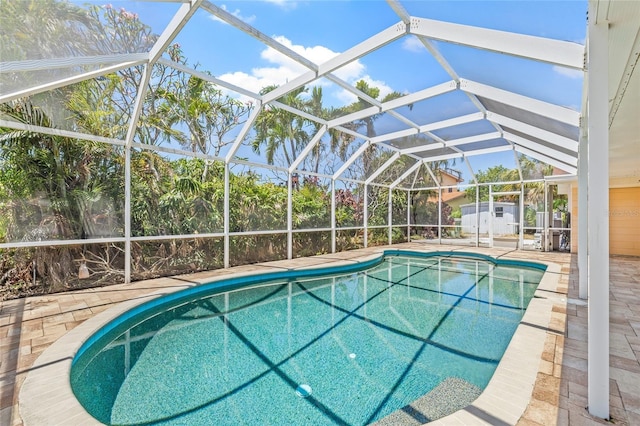 1141 80th Street Ct S, Saint Petersburg, FL 33707 - swimming pool with a patio, a lanai, and a storage shed