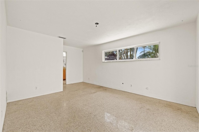 1141 80th Street Ct S, Saint Petersburg, FL 33707 - spare room with speckled floor and baseboards