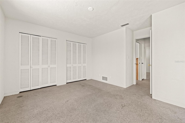 1141 80th Street Ct S, Saint Petersburg, FL 33707 - unfurnished bedroom with two closets, carpet, and baseboards