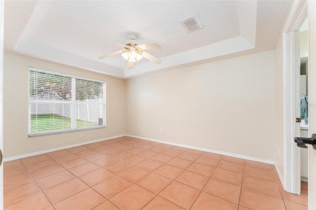 5607 Tanagergrove Way, Lithia, FL 33547 - empty room featuring light tile patterned floors, a raised ceiling, a ceiling fan, and visible vents