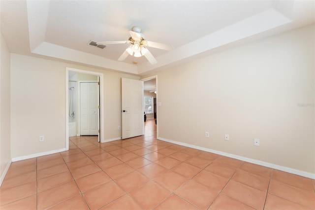 5607 Tanagergrove Way, Lithia, FL 33547 - unfurnished bedroom with visible vents, baseboards, a raised ceiling, and light tile patterned floors